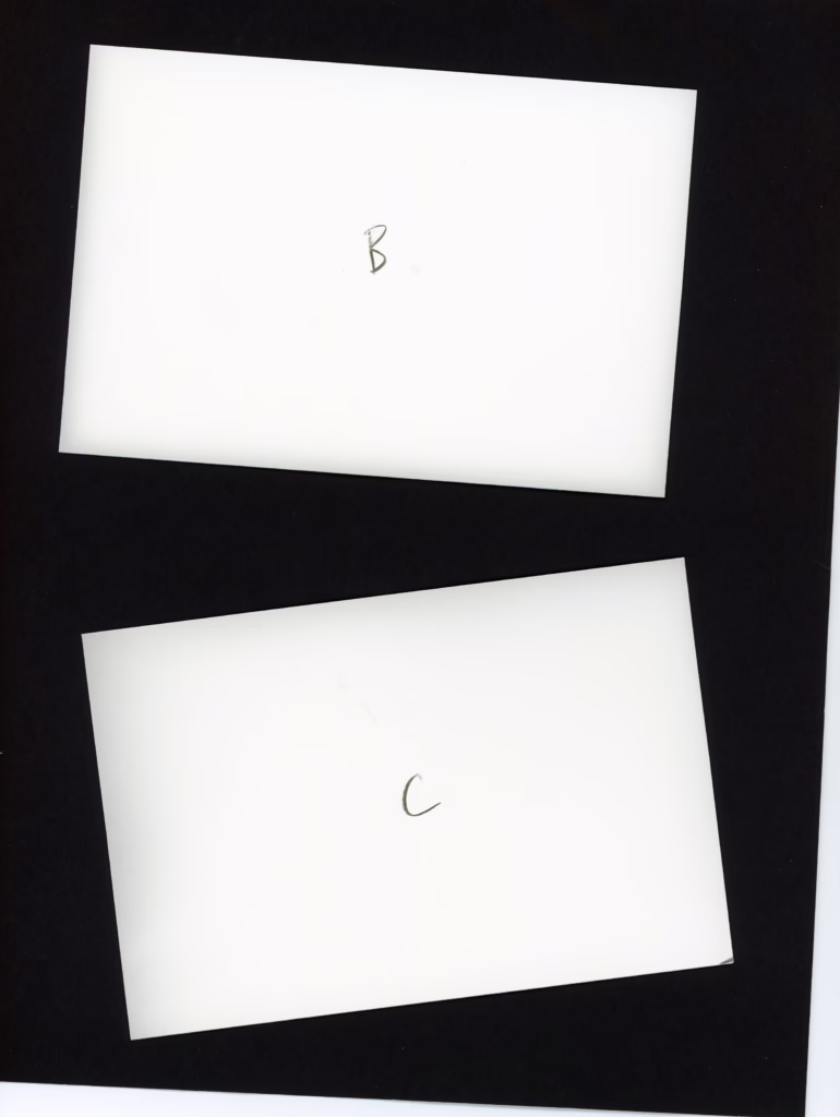 These two pieces of photographic paper were processed in complete darkness. One sheet had been exposed to a safelight and the other had not been. Both of these show edge fogging.