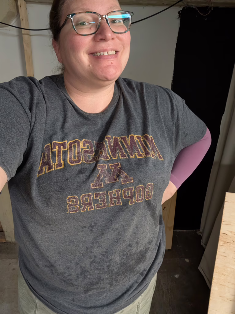 This selfie shows a very happy looking me in the darkroom. There is water all over the lower part of my grey t-shirt and I am smiling widely.