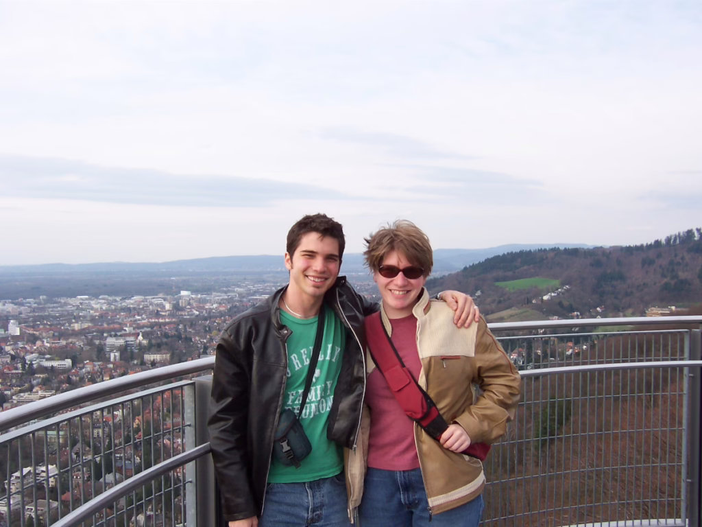 Photo of two people at Schlossberg observation tower in Freiburg, Germany, 2006. The city can be seen in the background.