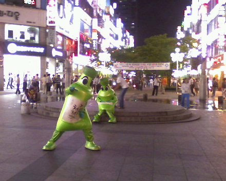 People dance in soju bottle costumes near Bomgye subway station in Anyang, South Korea