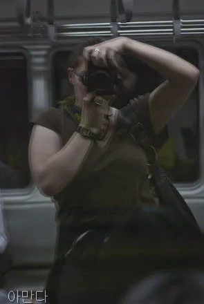 Self portrait taken inside a subway car.