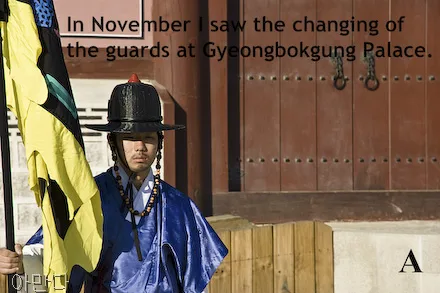 A man in traditional guard clothing does the changing of the guard ceremony at Gyeongbokgung Palace in Seoul, South Korea. The letter A is shown in the corner.